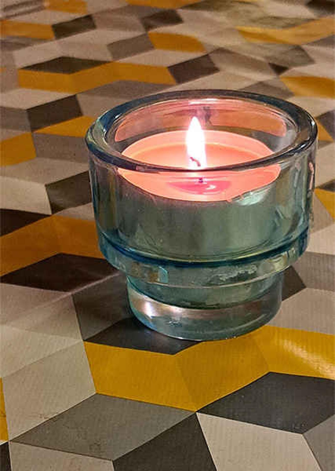 brennende Tischerze auf Tischtuch in den Farben Weiss-Schwarz-Gold